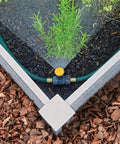 Adjustable Spike Sprinkler Bundle With Three Sprinklers And Two 15 Foot Hoses watering a corner garden bed evenly