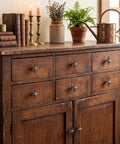 Wood dresser with six unique antique silver cast iron drawer pulls and cabinet knobs with 8 point star burst design.