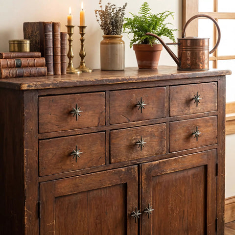 Wood dresser with six unique antique silver cast iron drawer pulls and cabinet knobs with 8 point star burst design.