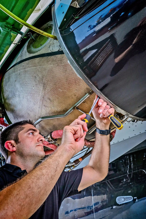 Technician using Phillips Head Screwdriver Size Two, 24-Inch Length, Dual Material Handle for Comfort, Speed Zone Grip for Fast Rotations.