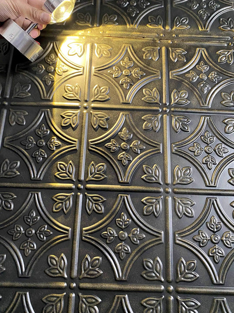 Close-up of embossed Tin Wall Tiles 24x24 Nail Up Black 5 Pack for Backsplash Ceiling and Stair Risers, 0.01 Inch Thick Metal Panels.