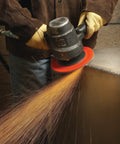 Worker using angle grinder with Fiber Disc 987C 36 Plus Grit Metal Grinding Disc, sparks flying during metal grinding.
