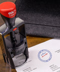 Rock Solid Heavy Duty Self Inking Date And Time Stamp With Custom Text Message and Crisp Black Ink on paperwork.