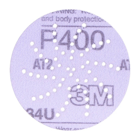 Front view of Cubitron II Hookit Clean Sanding Abrasive Disc 31465 with multi hole pattern for dust extraction, 3 inch 500+ grit.