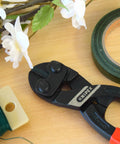 CoBolt Compact Bolt Cutter With Multi Component Design 8 Inch Comfort Grip for Tradesmen and DIY Pros shown on a workbench