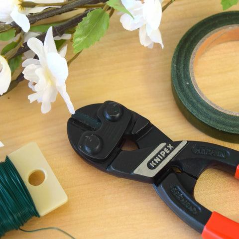 CoBolt Compact Bolt Cutter With Multi Component Design 8 Inch Comfort Grip for Tradesmen and DIY Pros shown on a workbench