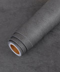 Extra Thick Matte Concrete Wallpaper Roll Peel And Stick Dark Grey Vinyl Contact Paper For Walls Furniture And Countertops DIY Friendly Durable Waterproof Bubble Free Easy Apply 12 By 317 Inches, rolled wallpaper on dark surface.