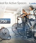 20 Inch Black High Velocity Wall Mount Fan With Pivoting Head used in a fitness space with exercise bikes, providing 2750 CFM airflow.