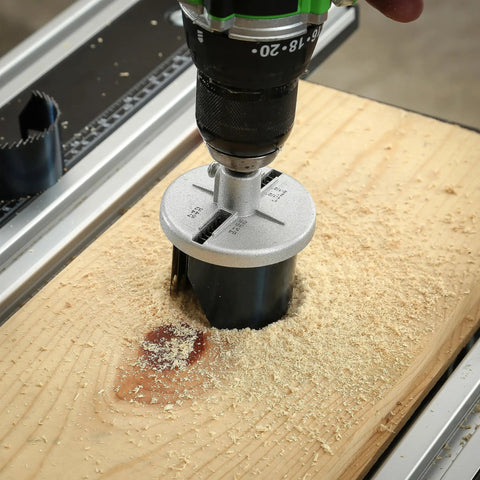 Seven In One Hole Saw Kit With One And Three Quarters Inch Depth Includes Seven Diameters cutting wood with drill on table
