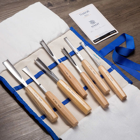 Pro Level Wood Carving Chisel Set Seven Piece Gouges With Cr-V 60 Steel Freakin Sharp Blades displayed on a canvas roll with ash handles.