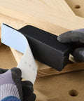 Hands applying StickFix abrasive sheet to Pocket StickFix Hand Sanding Block With Quick Change Hook And Loop System on wood surface