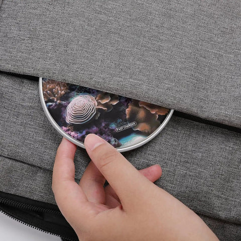 Travel Ready 10W Fast Wireless Charger Pad For Phones Ultra Slim Portable Charging Station Lightweight Desk Mat For Home Office Or On The Go 3.9 Inch Size Quick Power Up With Easy Setup being placed in a bag pocket