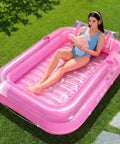 Woman relaxing on Inflatable Tanning Pool Lounger With Pillow 70 By 46 Inches Personal Water Filled Float For Backyard Chill