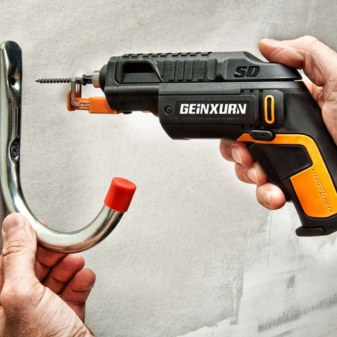 GEINXURN cordless impact driver side view with black and orange body driving screw into a metal wall hook