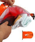 Open orange 28L dry bag from Swim Buoy For Open Water Swimmers With Adjustable Waist Belt, showing towels and phone inside.