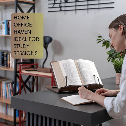 Person using Oak Wood Book Stand with Adjustable Tilt for reading in home office, holding a notebook, greenery and books in background