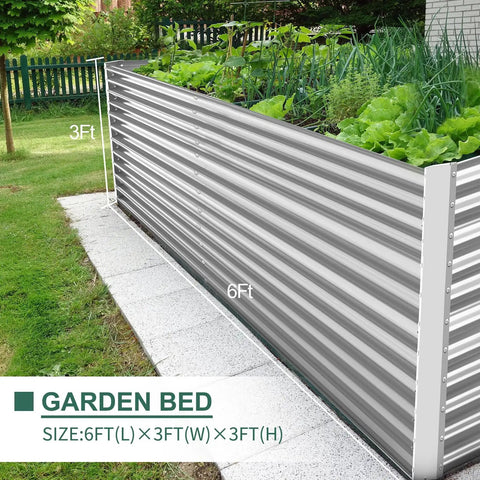Side view of a 6ft long galvanized metal planter box, raised 3ft tall, for outdoor gardening with vegetables, placed on a patio.