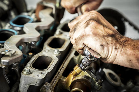 Mechanic using 176 Piece Socket Set With 1/4 3/8 And 1/2 Inch Drives 12 Point Standard And Deep SAE And Metric Sockets Off Corner Loading on engine
