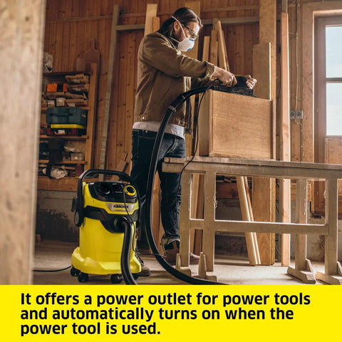Man using WD 5 P Shop Vacuum 6.6 Gal Wet Dry Vacuum Cleaner With 33 Ft Reach in a workshop