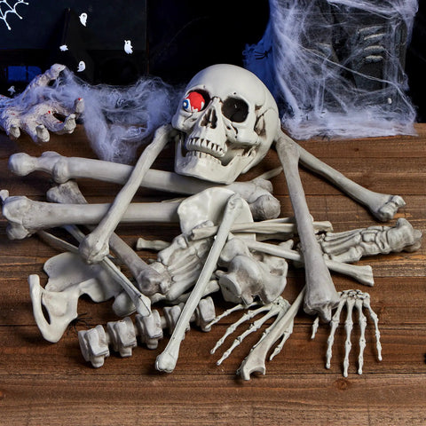 28 Piece Skeleton And Skull Halloween Decor Kit with bones, skull, and hand props on wooden background for spooky decoration.