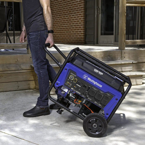 Man transporting Beast 6600 Watt Portable Generator For Home Backup With Remote Start and CO Sensor on wheels outdoor