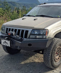 Flipster V3 Winch Plate Mounting System For 4x4s Featuring Hawse Roller And Recessed Fairlead Compatibility Stainless Hardware High Torque Hinge UV Rated Powder Coat Finish Built To Take On Tough Trails Fits Standard 10 Inch Winch Fairleads mounted on a Jeep front bumper
