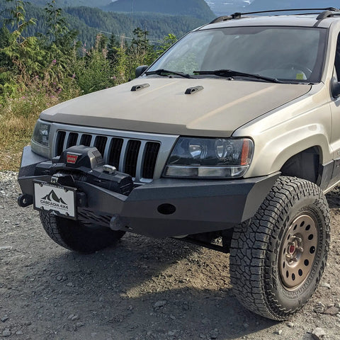 Flipster V3 Winch Plate Mounting System For 4x4s Featuring Hawse Roller And Recessed Fairlead Compatibility Stainless Hardware High Torque Hinge UV Rated Powder Coat Finish Built To Take On Tough Trails Fits Standard 10 Inch Winch Fairleads mounted on a Jeep front bumper