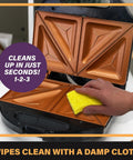 Gotham Steel Nonstick Panini Press And Sandwich Maker Grill With Indicator Light showing a hand cleaning the inner nonstick plates.