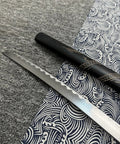 Dope Six Color Iaido Training Katana Set With 1060 Carbon Steel Blades, close-up of sword blade with dragon engravings on textiles.