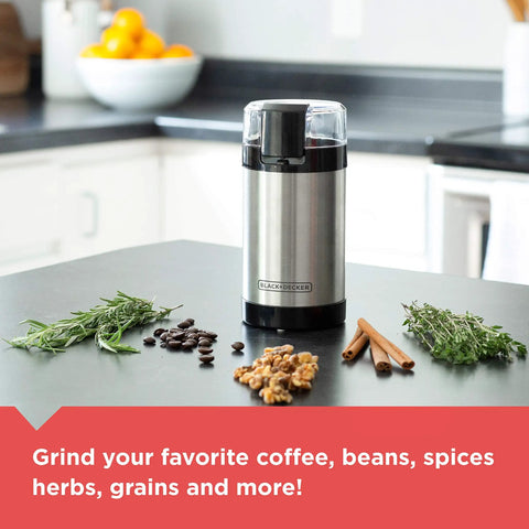 One Touch Coffee And Spice Grinder With Stainless Steel Blades And Bowl Two Thirds Cup Capacity Powerful 150 Watt Motor Quick Even Grinds For Coffee Beans Herbs Grains And Spices Easy Push Button Control, shown on a kitchen counter with herbs and coffee beans.