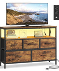App Controlled Led Dresser With Charging Station And Five Drawer Chest Tv Stand Industrial Rustic Brown Ink Black Bedroom Furniture For Your Major Bedroom Glow Up with TV on top.