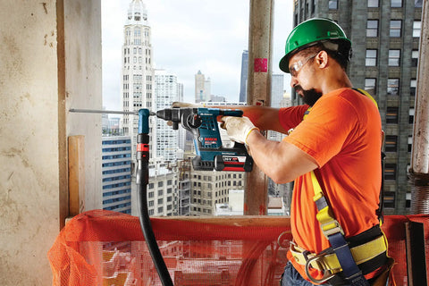 Construction worker using Workhorse SDS-Plus Bulldog Rotary Hammer Bit 1/4 Inch By 6 Inch with two cutter head on concrete wall.