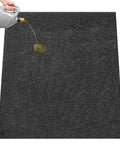 Garage Floor Mat For Oil Spills 29 By 36 Inches Reusable And Washable Oil Absorbent Pad With Waterproof Backing Protects Concrete Driveway And Garage Floor Black, with oil being poured on it.