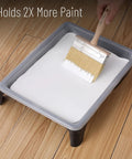Wide 5 Inch Deck Stain Brush With Wooden Handle in paint tray on wooden floor
