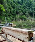 Chainsaw Mill Winch Kit With Lever Arm for hardwood milling in a lush forest setting