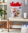Totally Extra Large Paw Patrol Gift Bag With Tissue Paper For Birthdays And Parties, showing pups on white bag with red tissue