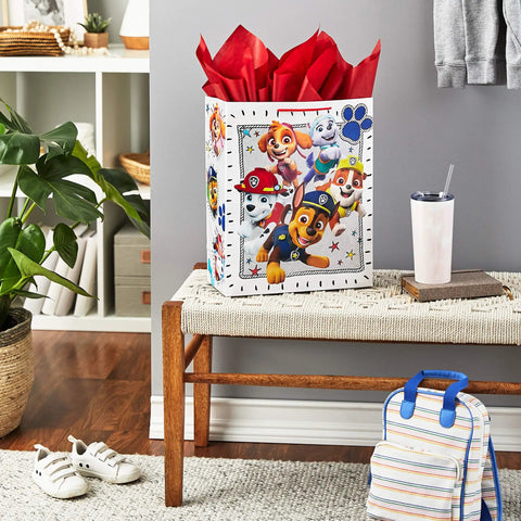 Totally Extra Large Paw Patrol Gift Bag With Tissue Paper For Birthdays And Parties, showing pups on white bag with red tissue