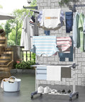 Top Shelf Oversized Four Tier Clothes Drying Rack With A Built Tough Foldable Frame Plus Side Wings For Hanging Laundry Towels Shoes And Quilts Roomy Air Drying Setup with clothes drying outdoors.