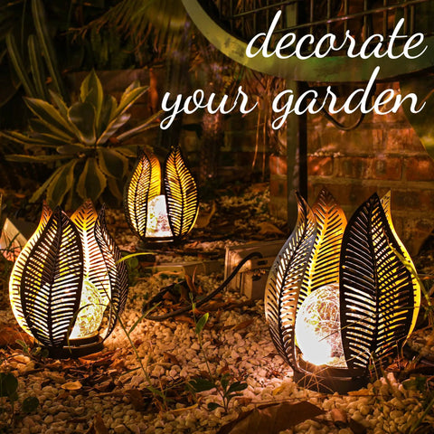 Solar Garden Lights Dope Waterproof Decor Crackle Globe Glass With Metal Palm Leaf Design in outdoor patio at night
