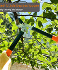 Powerful Gear Action Pruner with sharp steel blade cutting a branch, lightweight 15-inch garden clippers for hedging bushes.