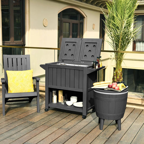 85 Quart Rolling Patio Cooler Cart With Built In Bottle Opener And Drainage on wheels, black, on a deck with plants and chair
