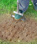 Person using Semi Assembled Lawn Aerator With Four Steel Spikes Non Clogging Design Ergonomic Handle on compacted soil