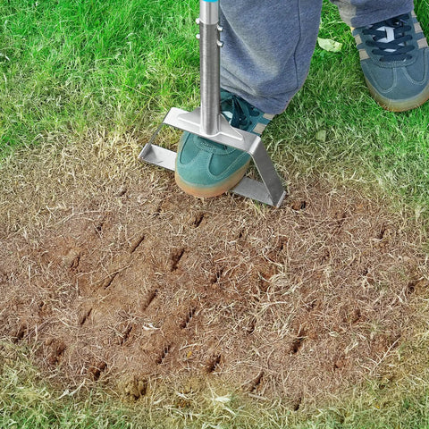 Person using Semi Assembled Lawn Aerator With Four Steel Spikes Non Clogging Design Ergonomic Handle on compacted soil