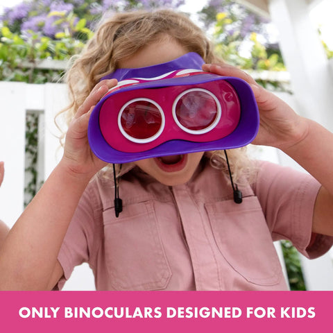 Child using Pink Kidnoculars Lightweight Kids Binoculars for Outdoor Adventures with neck strap, smiling outdoors.