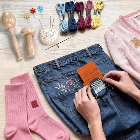 Using Speedweve Style Darning Loom Kit With 14 And 28 Hook Looms to mend jeans, surrounded by color threads and darning tools.