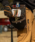 Worker using TrapJaw Oil Tan Leather Tool Pouch With Front Access, Wide Opening Snap Closure for tools, model 1L-995-1.