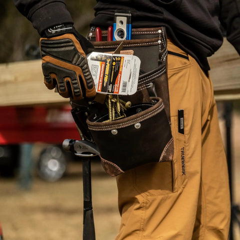 Worker using TrapJaw Oil Tan Leather Tool Pouch With Front Access, Wide Opening Snap Closure for tools, model 1L-995-1.