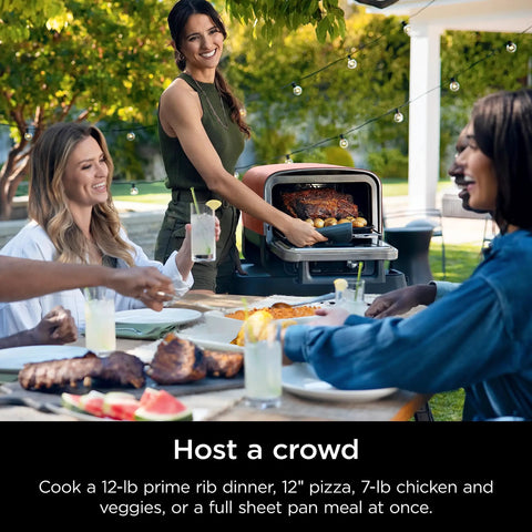 Person using Woodfire Outdoor Pizza Oven 8 In 1 Portable Electric Roaster Heats Up To 700 Degrees Fahrenheit on patio