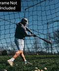 Man practicing with 40 Foot Batting Cage Net Stand Alone Net Only For Backyard Baseball And Softball Practice Professional Grade Netting