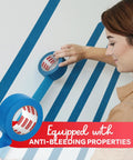 Person applying Blue Painter Tape 2 Inch By 60 Yards Bulk 12 Roll Pack with Sharp Edge Line Technology on wall trim for crafts.
